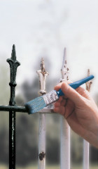 A metal fence being painted with Hammerite Direct to Rust